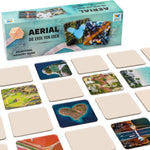 Spielmaterial des Memospiels Aerial mit Verpackung und ausgelegten Luftbildkarten aus aller Welt.