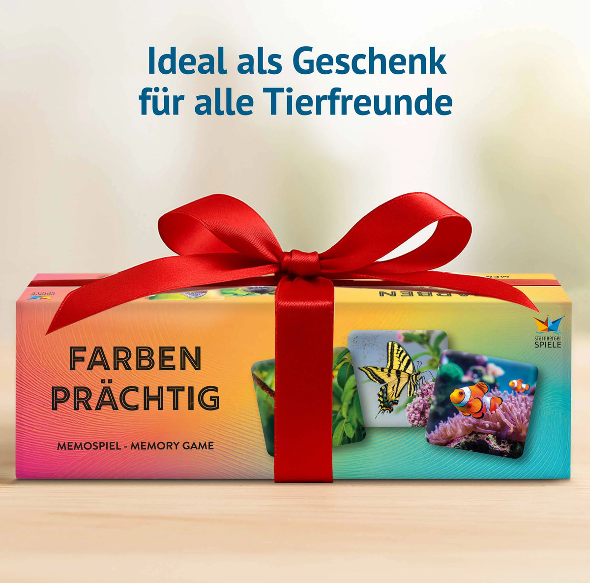 Farbenprächtig Memospiel als Geschenk für Tierfreunde. Die Geschenkverpackung mit roter Schleife zeigt farbenfrohe Tiermotive und eignet sich als Geschenkidee für Kinder, Erwachsene und die ganze Familie.